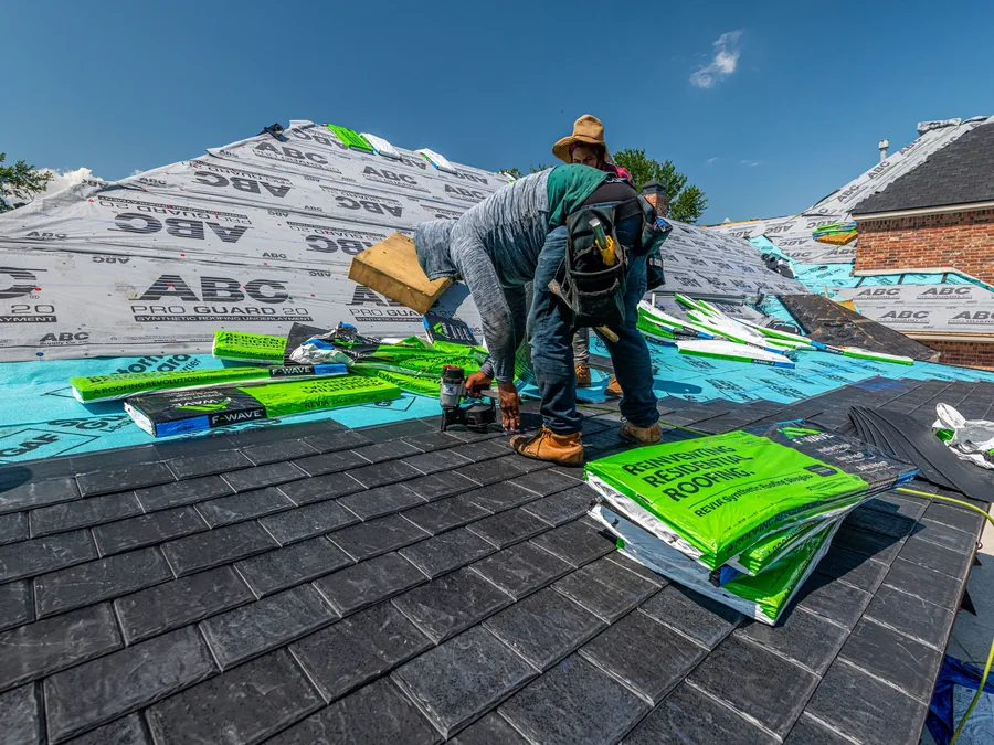 Roofers laying underlayment