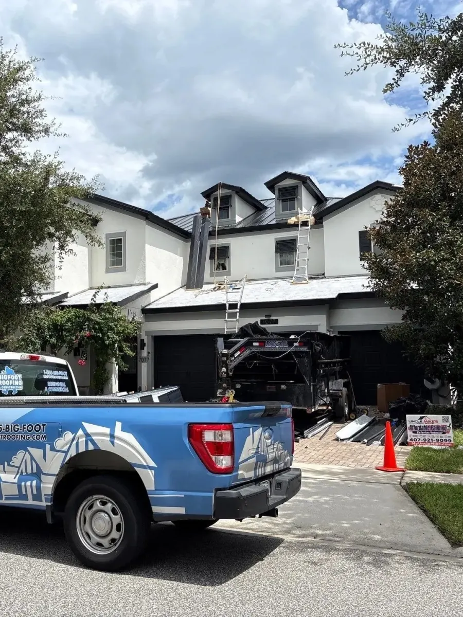 Bigfoot Roofing truck outside a home